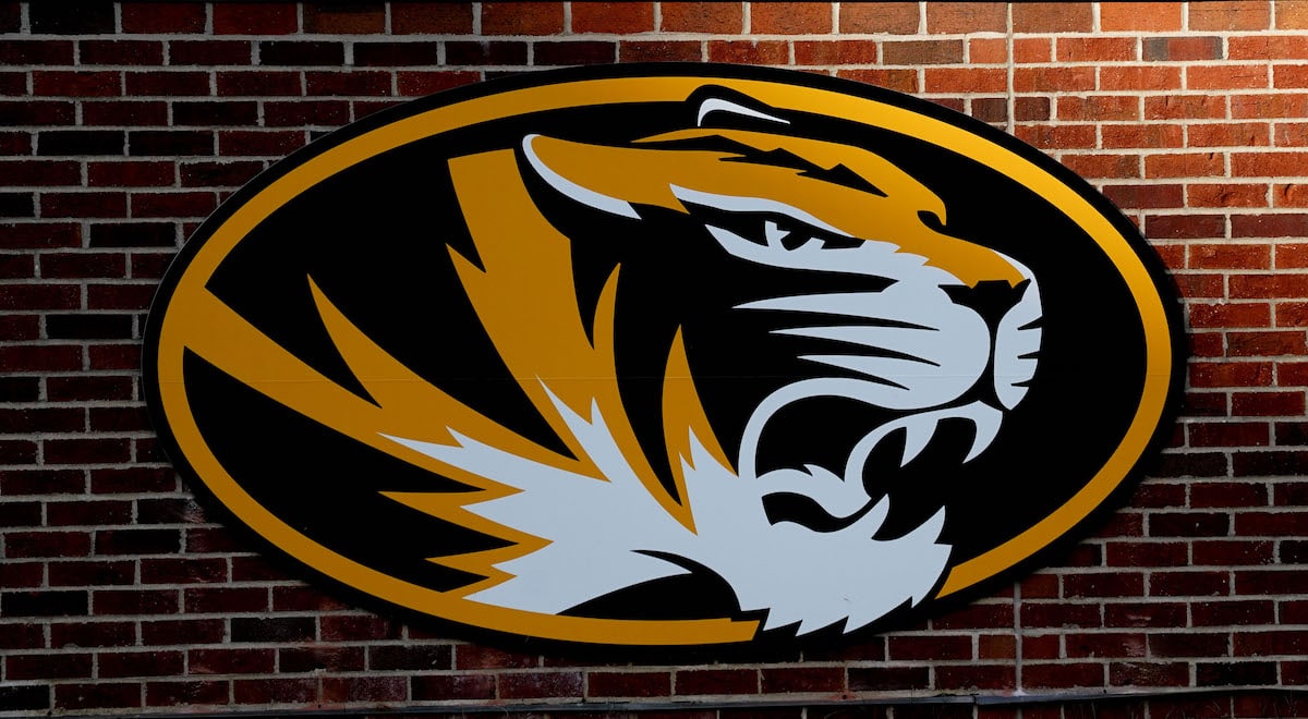 Mizzou logo on a brick wall.